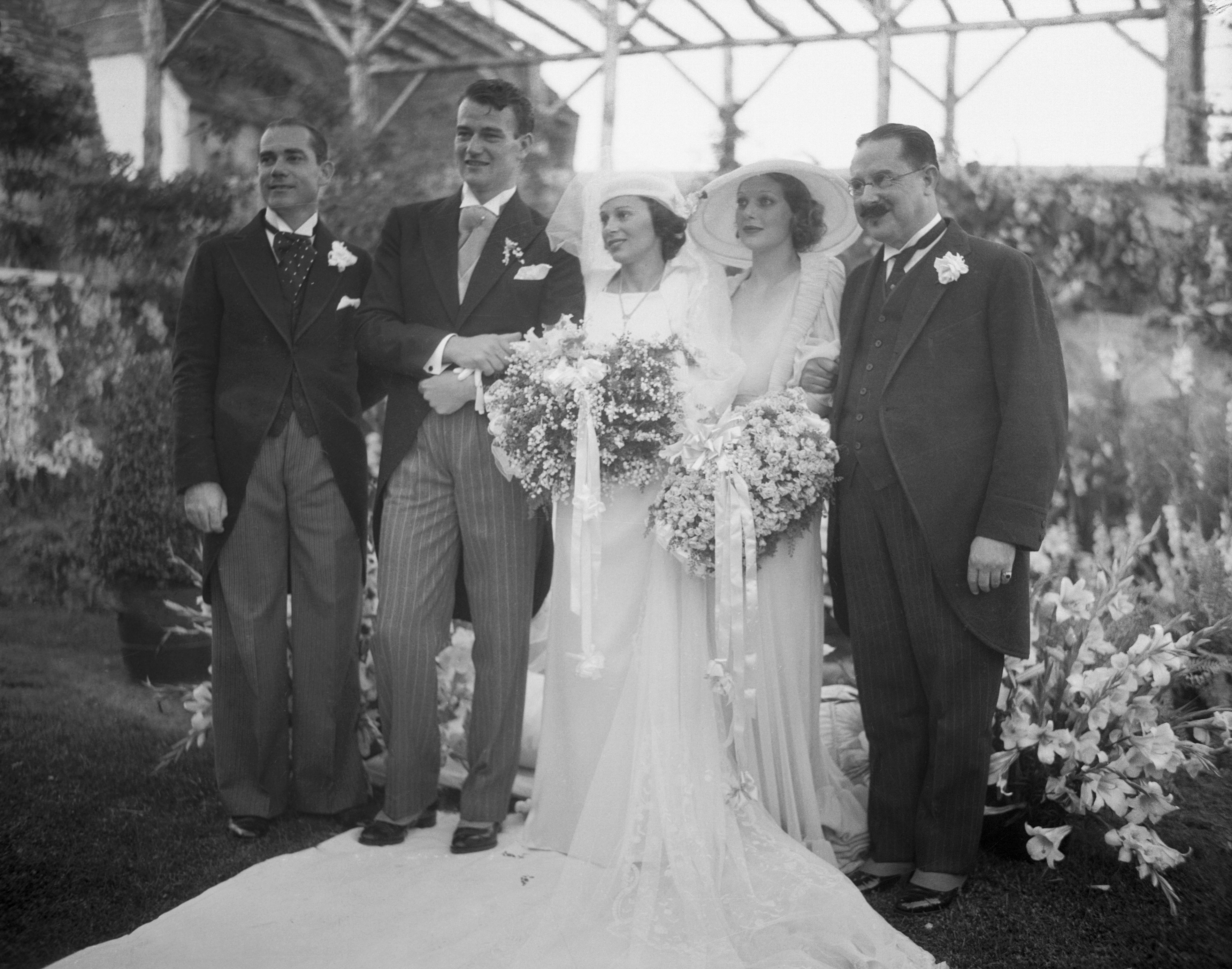  Screen actor Weds Daughter Of Latin American Consul. John Wayne, motion picture actor, and his bride, the former Miss Josephine Saenz, Panamanian Consul in Los Angeles, shown after their marriage at the Los Angeles home of Loretta Young,| Source: Getty Images