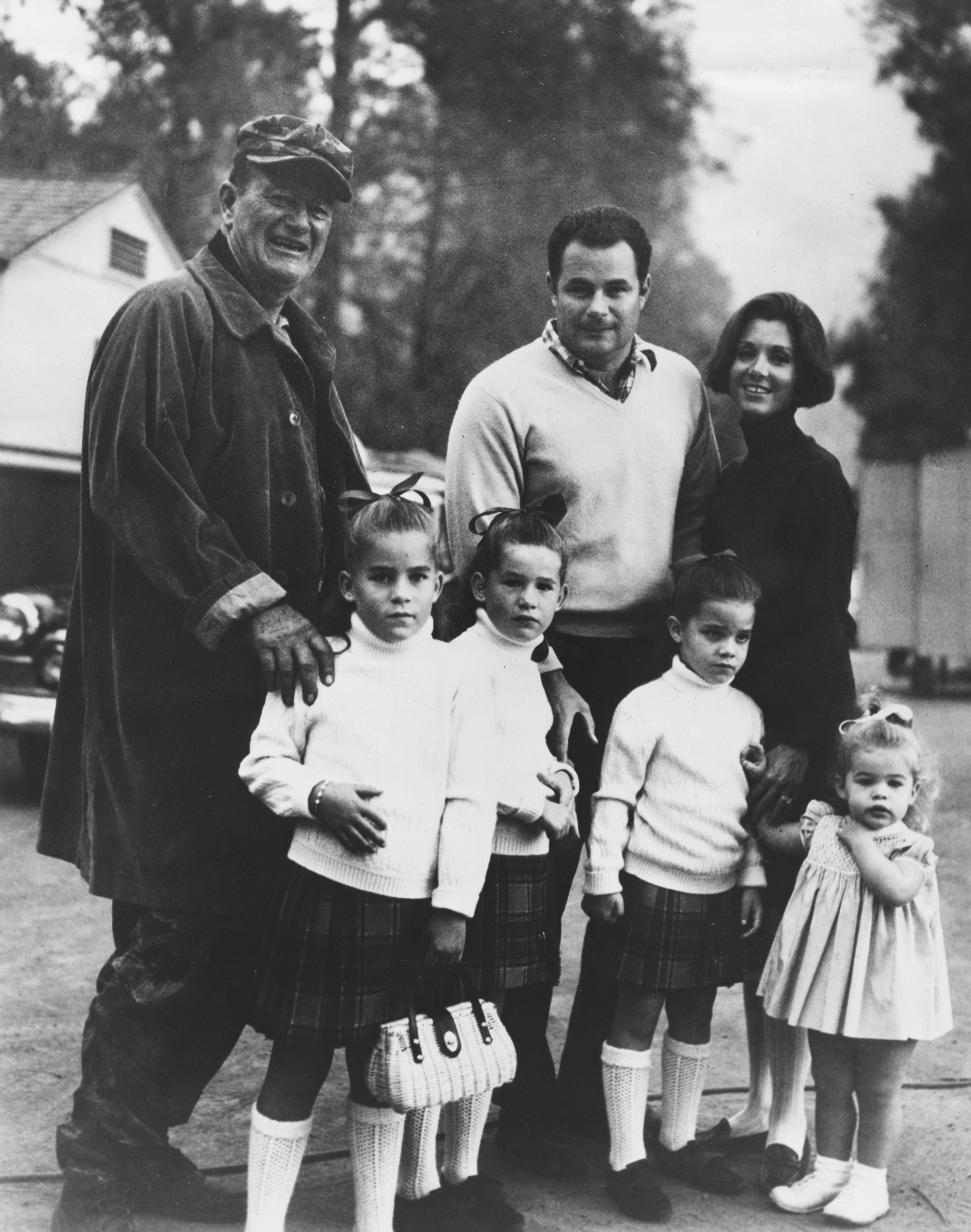 Portrait of actor John Wayne, with his son Michael, daughter-in-law Gretchen, and granddaughters Alicia, Maria, Teresa and Josephine, March 19th 1968 | Source: Getty Images